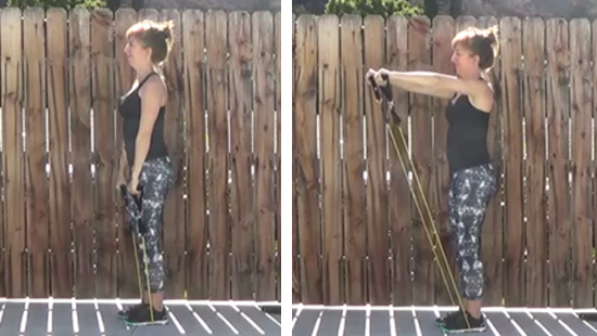 Personal trainer performing front raise with resistance tubing