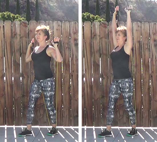 Personal trainer performing overhead press with resistance band