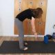 yoga teacher demonstrating forward fold done incorrectly
