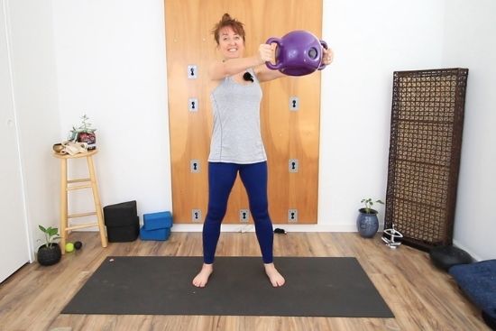 personal trainer demonstrating figure 8 shoulder stabilization exercise